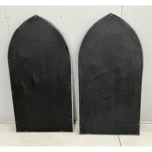 84 - A pair of modern Gothic style arched window frame style wall mirrors, width 71cm, height 138cm