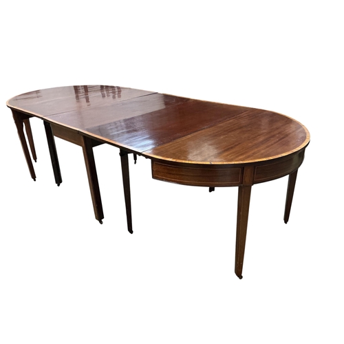 1027 - A George III satinwood banded mahogany D end extending dining table, with two spare leaves, 284cm ex... 