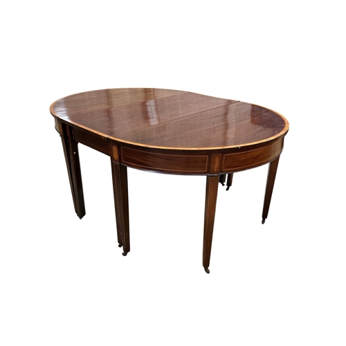 1027 - A George III satinwood banded mahogany D end extending dining table, with two spare leaves, 284cm ex... 