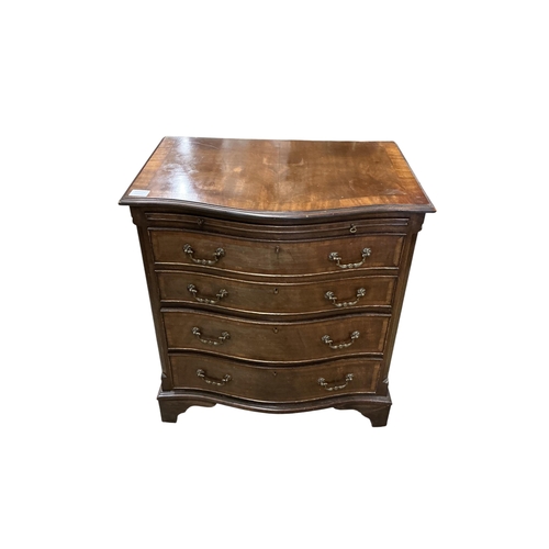 1035 - A pair of reproduction George III style serpentine mahogany four drawer chests with brushing slides,... 