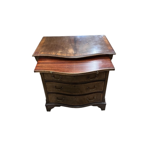 1035 - A pair of reproduction George III style serpentine mahogany four drawer chests with brushing slides,... 
