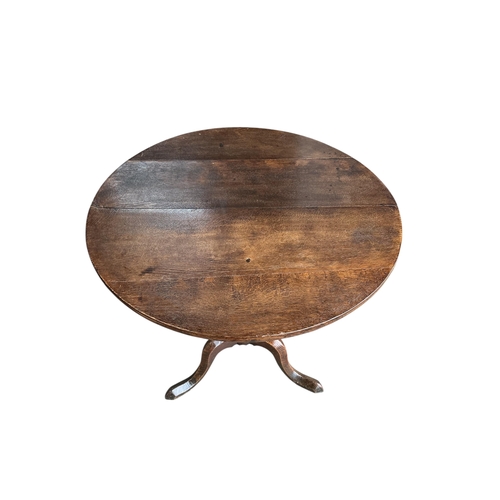 2002 - An early 19th century circular oak tilt top tripod tea table, diameter 76cm, height 72cm