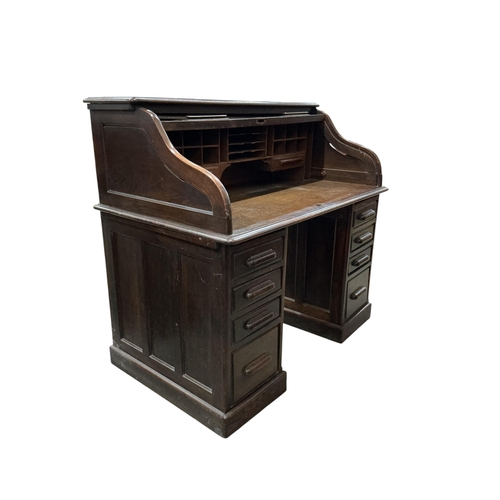 2035 - An early 20th century oak 'S' shaped tambour roll top desk, width 124cm, depth 78cm, height 120cm... 