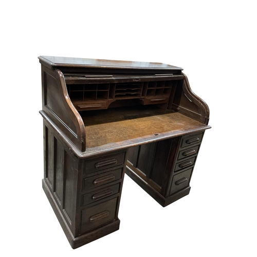 2035 - An early 20th century oak 'S' shaped tambour roll top desk, width 124cm, depth 78cm, height 120cm... 