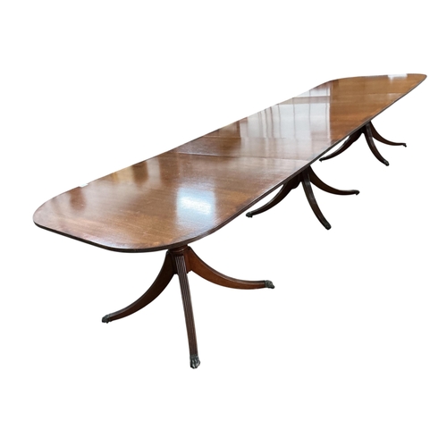 2052 - A reproduction George III style mahogany triple pillar extending dining table, width 500cm extended,... 