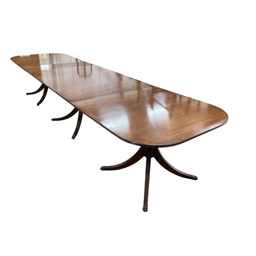 2052 - A reproduction George III style mahogany triple pillar extending dining table, width 500cm extended,... 