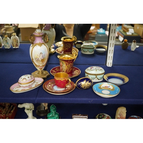 2468 - A collection of porcelain to include a Vienna cabinet cup and saucer,  continental ormolu mounted ur... 