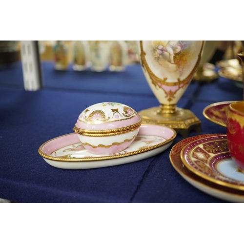 2468 - A collection of porcelain to include a Vienna cabinet cup and saucer,  continental ormolu mounted ur... 