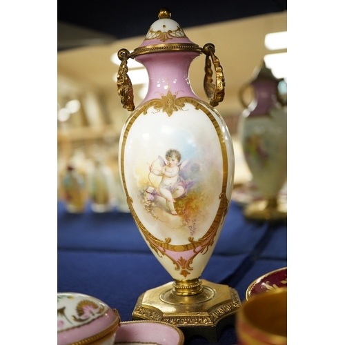 2468 - A collection of porcelain to include a Vienna cabinet cup and saucer,  continental ormolu mounted ur... 