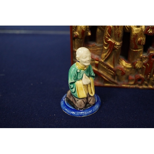 2479 - A Chinese carved and giltwood panel, sancai figure and carved coquilla nut, largest 21 x 14.5cm... 