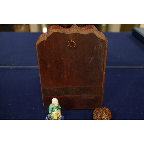2479 - A Chinese carved and giltwood panel, sancai figure and carved coquilla nut, largest 21 x 14.5cm... 