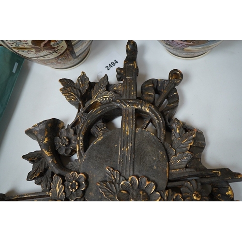 2494 - A folk art partially gilt carved panel, 50cm high