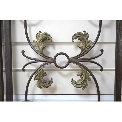 A pair of French wrought iron gates, c.1900, decorated with sinuous ...
