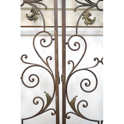A pair of French wrought iron gates, c.1900, decorated with sinuous ...