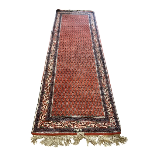 1067 - A Saraband red ground runner, 248 x 82cm