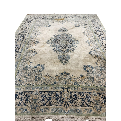 1072 - An Indian ivory ground carpet, 360 x 270cm (stained in several places)