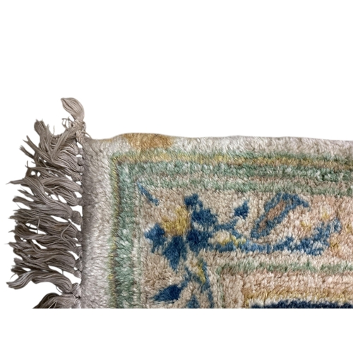 1072 - An Indian ivory ground carpet, 360 x 270cm (stained in several places)