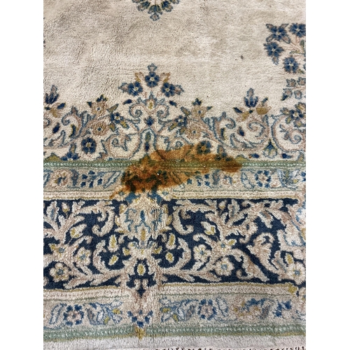 1072 - An Indian ivory ground carpet, 360 x 270cm (stained in several places)