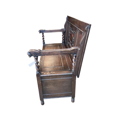 1075 - An early 20th century carved oak monk's bench, width 114cm, depth 54cm, height 93cm