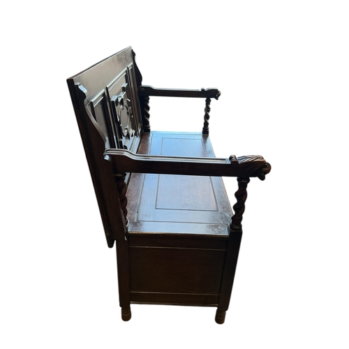 1075 - An early 20th century carved oak monk's bench, width 114cm, depth 54cm, height 93cm