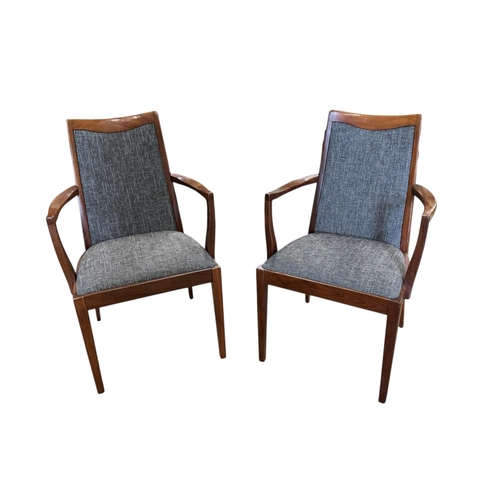 1076 - A set of eight mid century G Plan Fresco teak dining chairs, with drop-in seats, two with arms, with... 