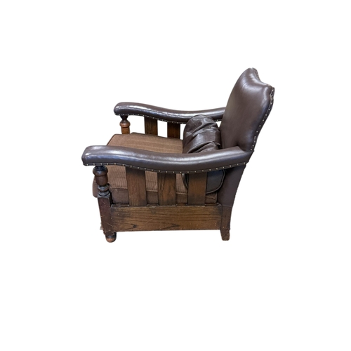 1082 - A near pair of early 20th century brown leather and fabric upholstery oak club armchairs, larger wid... 