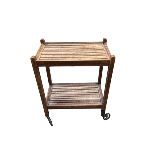 1097 - An early 20th century oak two tier trolley by Castles, London, width 55cm, depth 39cm, height 84cm... 