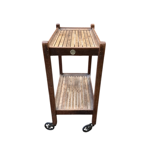 1097 - An early 20th century oak two tier trolley by Castles, London, width 55cm, depth 39cm, height 84cm... 