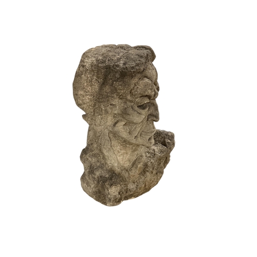 1111 - A carved stone head, height 69cm