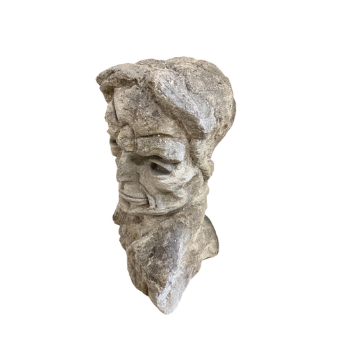 1111 - A carved stone head, height 69cm
