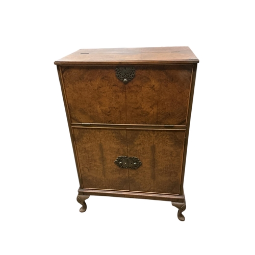 1112 - A walnut veneer cocktail cabinet, width 74cm, depth 42cm, height 116cm, containing decanters, shaker... 