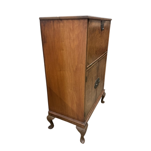 1112 - A walnut veneer cocktail cabinet, width 74cm, depth 42cm, height 116cm, containing decanters, shaker... 