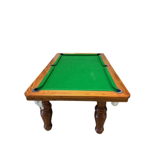 1128 - An oak snooker / dining table with rise and fall action, cues balls and accessories, width 218cm, de... 