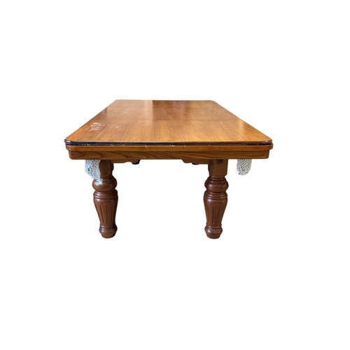 1128 - An oak snooker / dining table with rise and fall action, cues balls and accessories, width 218cm, de... 