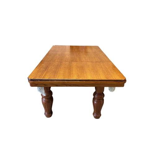 1128 - An oak snooker / dining table with rise and fall action, cues balls and accessories, width 218cm, de... 