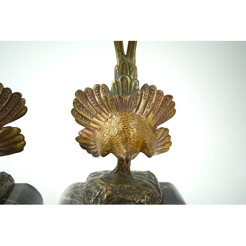 1251 - A pair of bronze peacock bookends, with remains of coloured pigments, marble plinths, signed R. Lecl... 