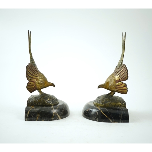 1251 - A pair of bronze peacock bookends, with remains of coloured pigments, marble plinths, signed R. Lecl... 