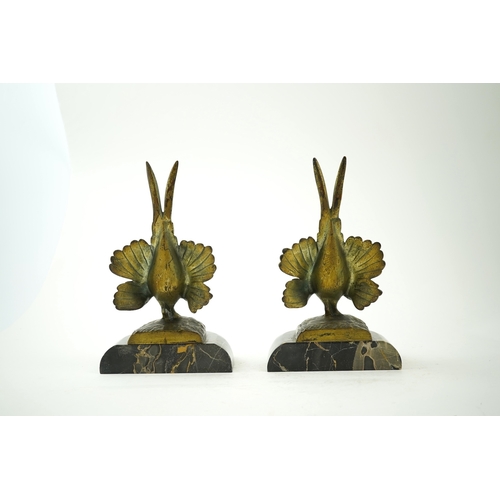 1251 - A pair of bronze peacock bookends, with remains of coloured pigments, marble plinths, signed R. Lecl... 