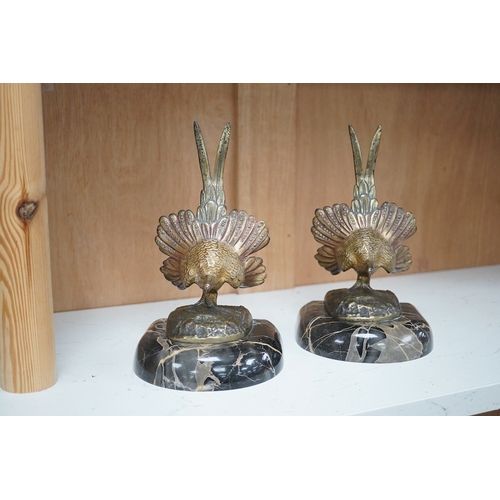 1251 - A pair of bronze peacock bookends, with remains of coloured pigments, marble plinths, signed R. Lecl... 