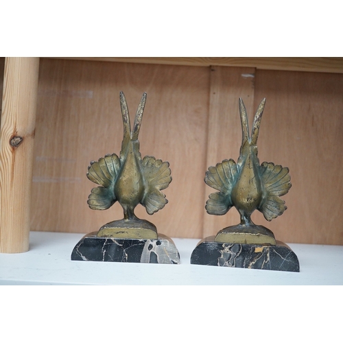 1251 - A pair of bronze peacock bookends, with remains of coloured pigments, marble plinths, signed R. Lecl... 