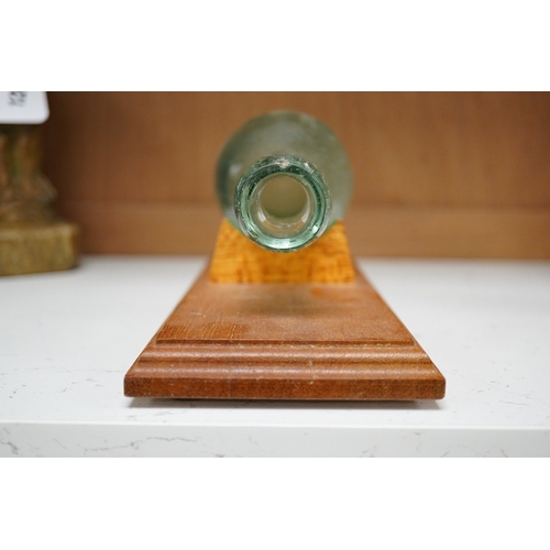 1263 - A Shoolbred & Co pressed glass bottle, on stand, bottle  25cm