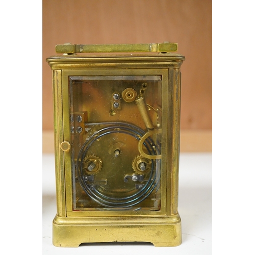 1264 - An early 20th century lacquered brass repeating carriage clock and a smaller carriage timepiece, hei... 