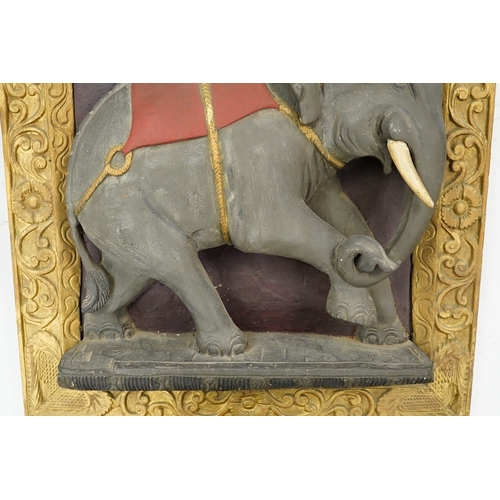 1295 - A giltwood panel with a carved elephant relief, 54cm x 53cm