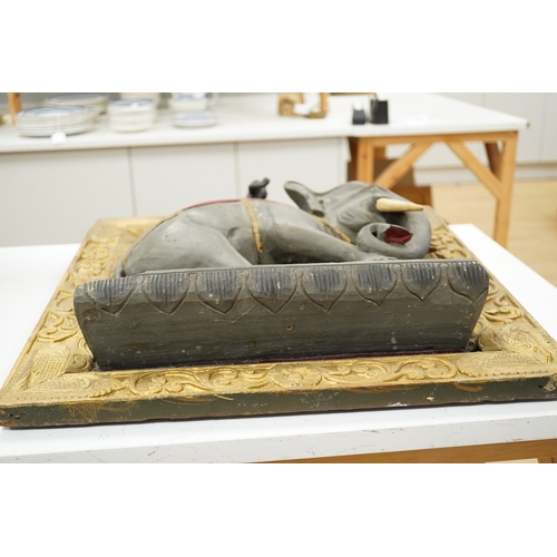1295 - A giltwood panel with a carved elephant relief, 54cm x 53cm