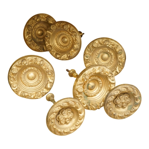 277 - Seven Victorian circular embossed brass curtain tie backs, 17cm diameter