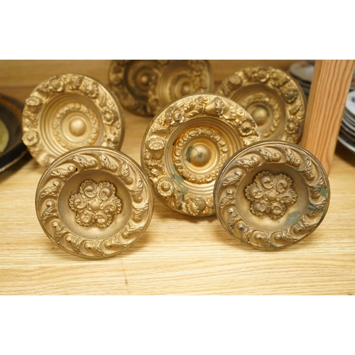 277 - Seven Victorian circular embossed brass curtain tie backs, 17cm diameter