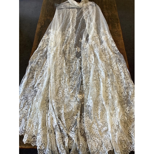 104 - An early 20th century Brussels bobbin lace wedding veil and later Carrickmacross lace stole. The vei... 