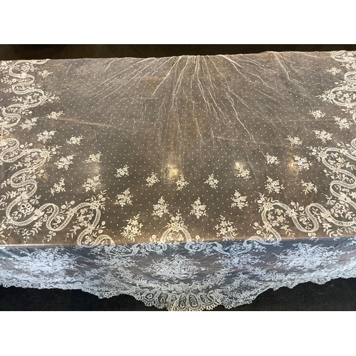 104 - An early 20th century Brussels bobbin lace wedding veil and later Carrickmacross lace stole. The vei... 