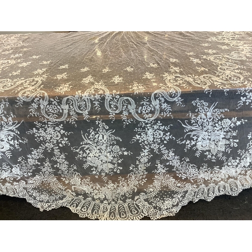 104 - An early 20th century Brussels bobbin lace wedding veil and later Carrickmacross lace stole. The vei... 