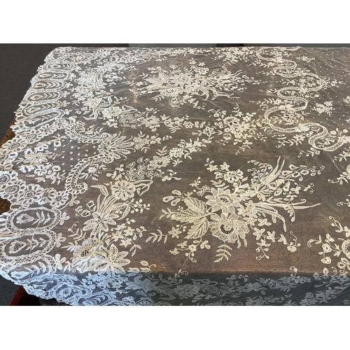 104 - An early 20th century Brussels bobbin lace wedding veil and later Carrickmacross lace stole. The vei... 